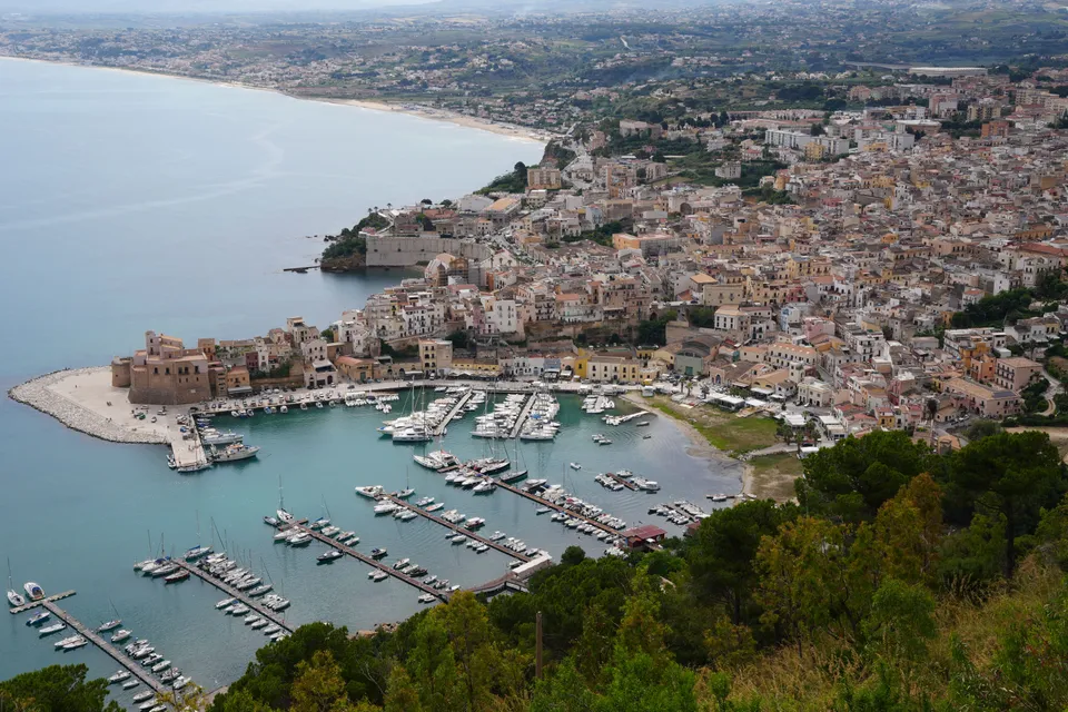 Stunning aerial shot of Castellammare del Golfo's marina and town in Sicily, Italy.
